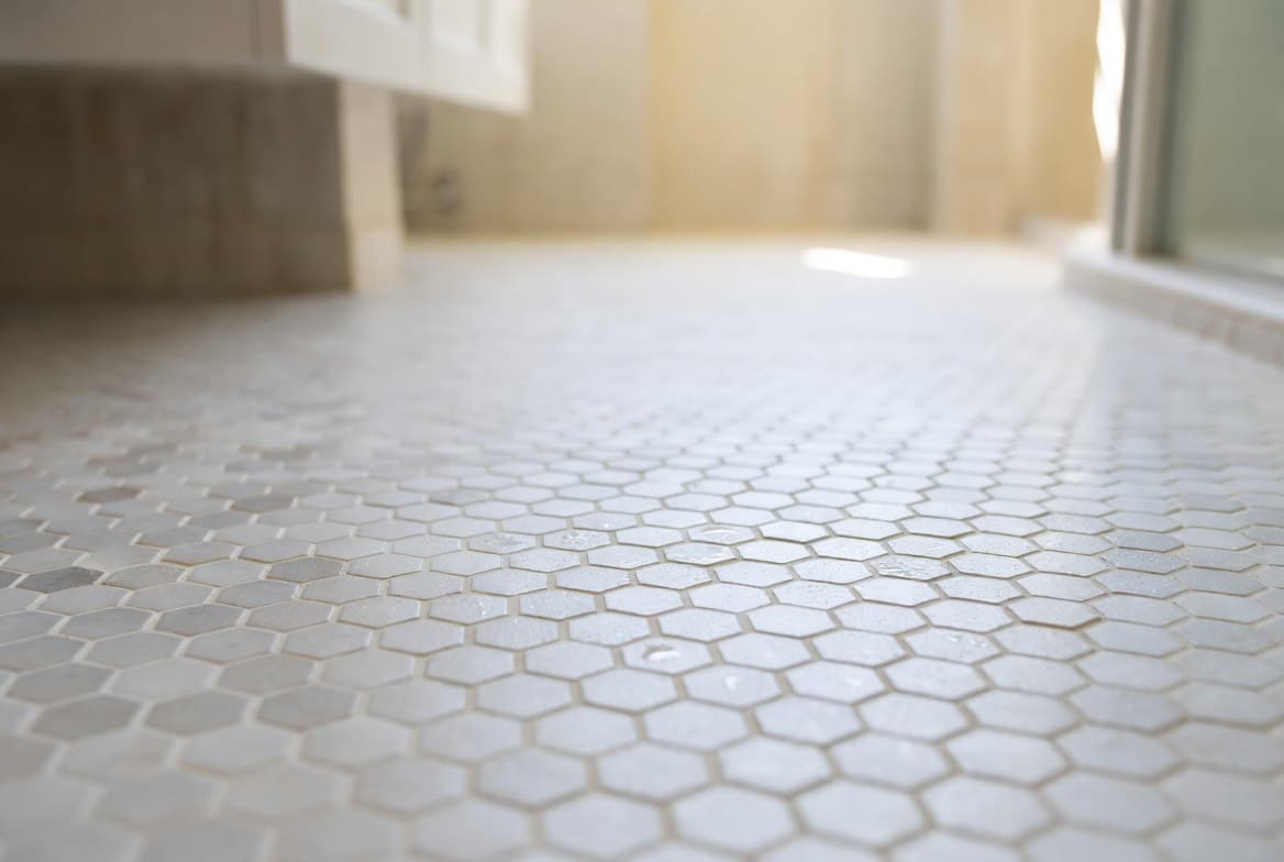 Close-up of textured, non-slip hexagonal bathroom floor tile with a matte finish