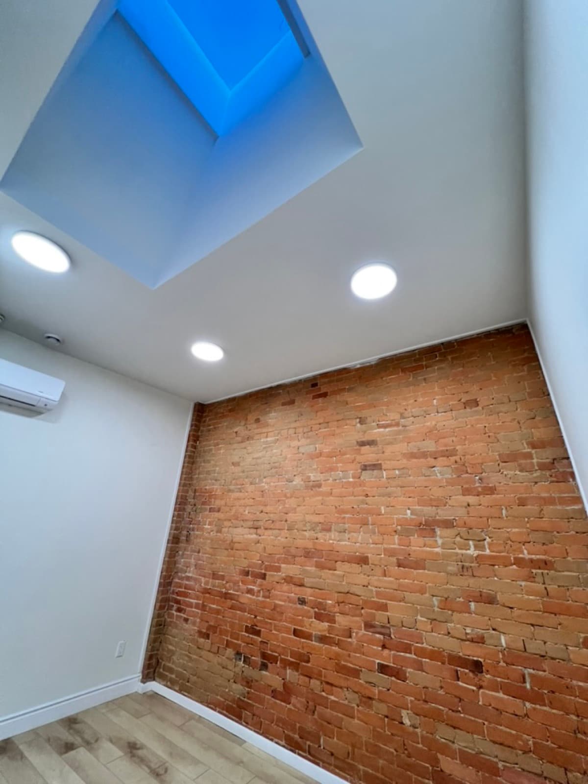 A new skylight above a brick accent wall