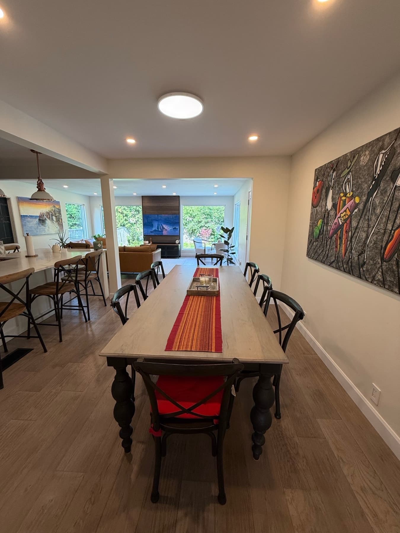 A wide opening from a dining room into the living room, with the kitchen island to one side